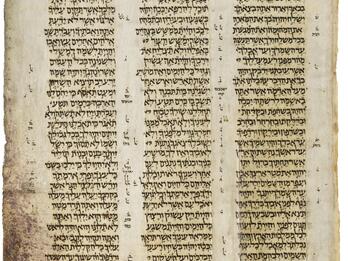Manuscript page with three columns of Hebrew text, with smaller writing in the margins and between columns.