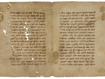 Facing pages of a worn, handwritten book in Hebrew script.