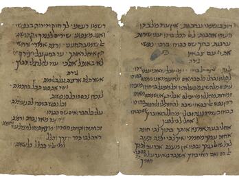 Worn and stained facing manuscript pages in Hebrew script.