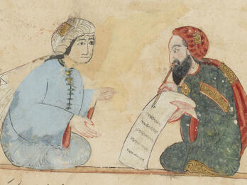 Colorful illustration showing two facing seated figures in robes and long turbans, one bearded and writing on a scroll with a pen and the other gesturing.