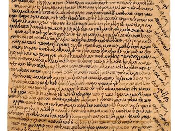 Damaged, long parchment densely filled with vowelless Hebrew writing, including diagonal lines filling the top and right margins.