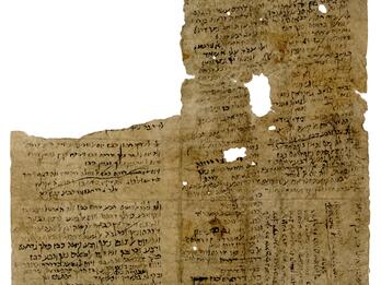 Damaged, irregular manuscript fragment with holes and roughly handwritten vowelless Hebrew filling the page in various directions, with a few sections crossed out.