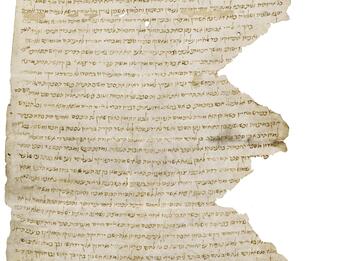 Damaged and torn parchment, especially in a zig-zag pattern on the right, with fading vowelless Hebrew script, largely as a long paragraph with two smaller columns above and one below.