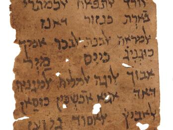 Damaged vertical parchment with fifteen lines of vowelless Hebrew script below two simple drawings, with several holes and tears.