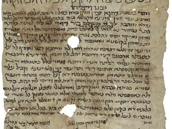 Damaged, stained parchment with vowelless Hebrew script, larger and decorated with floral elements at the top and in an irregular arrangement at the bottom, with two large and several small holes.