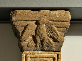 Photo of a stone capital featuring a relief of an eagle.