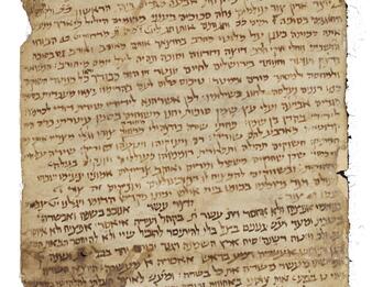 Long, stained parchment scroll with dense Hebrew script.