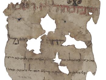 Irregular, tattered manuscript fragment with large Hebrew script in red with black and red decorations, then large plain black script, and then smaller black script.