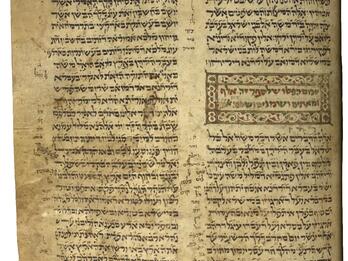 Damaged Hebrew manuscript page written as a paragraph followed by staggered lines, with a colorful geometric and floral border, multicolored words, and small, vowelless annotations in the margins, and more notes and decorated micrgraphy around the edges.