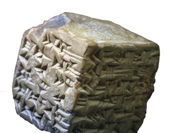 Stone cube inscribed with cuneiform. 
