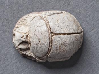 Stone cylinder resembling beetle.