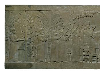 Relief of figure on chair and figure reclining on sofa, surrounded by foliage, as several smaller figures wave fans, carry platters, and play instruments. 