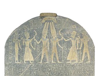 Stone with rounded top with drawing of six figures wielding weapons and Egyptian hieroglyphic writing in rows.
