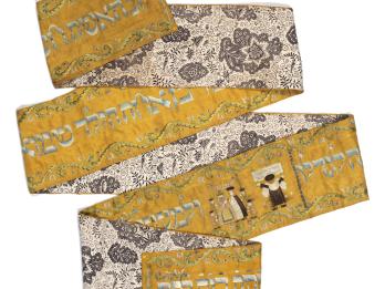Long rectangular cloth folded in several places, with floral design on one side and Hebrew text on the other side, with image of person reading from the Torah and couple under a wedding canopy. 