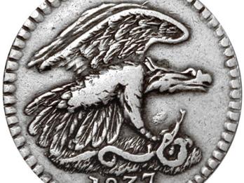 Silver coin featuring eagle and snake.