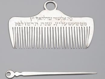 Silver comb and nail pick.