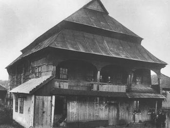 Photograph of wooden building with tiered triangular roof.