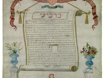 Paper with central Aramaic text surrounded by drawn scroll, eagle holding shield with American flag, two cherubs holding a sign with English words on it, and flowers on columns below text.