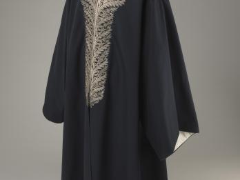 Coat with an ornately embroidered neckline.
