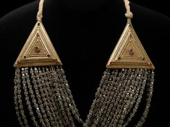 Necklace with triangular settings on either side, with strings of beads running between them.