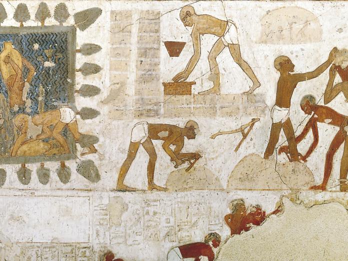 Mural of people carrying bricks, measuring blocks, and pouring buckets. 