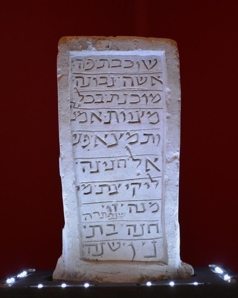 Upright stone slab engraved with a simple relief of a horn.