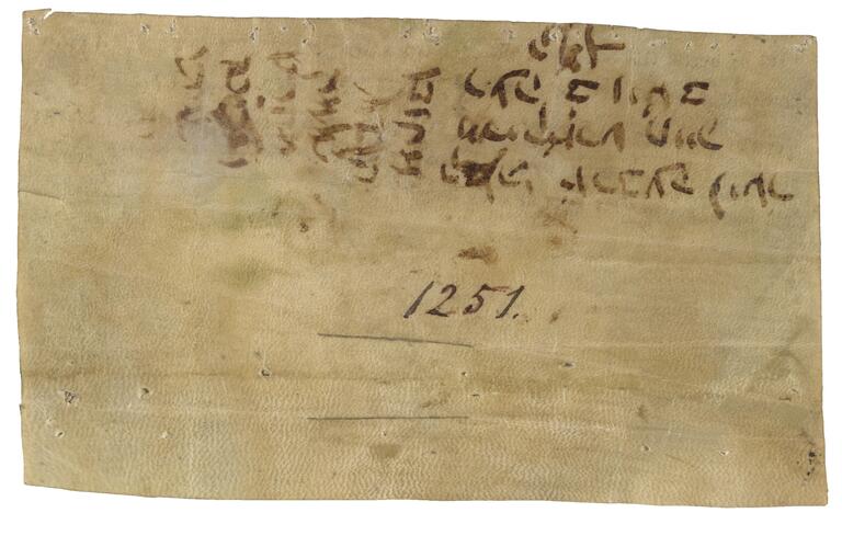 Parchment with brown Hebrew script upside-down and sideways toward the top, followed by the number 1251 in the center of the page, the rest of which is blank.