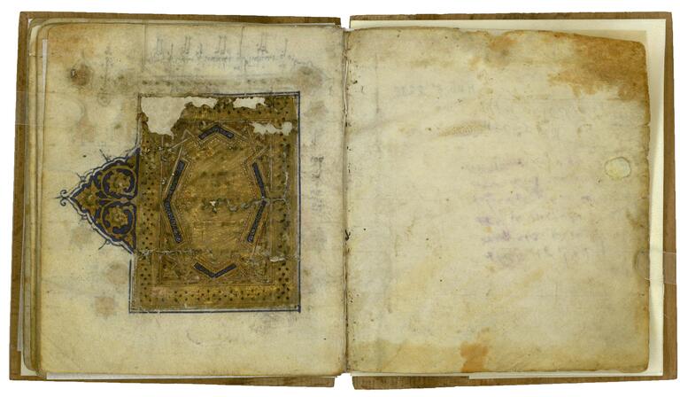 Book open to two facing pages, with a damaged gold geometric and floral pattern with blue and black details.