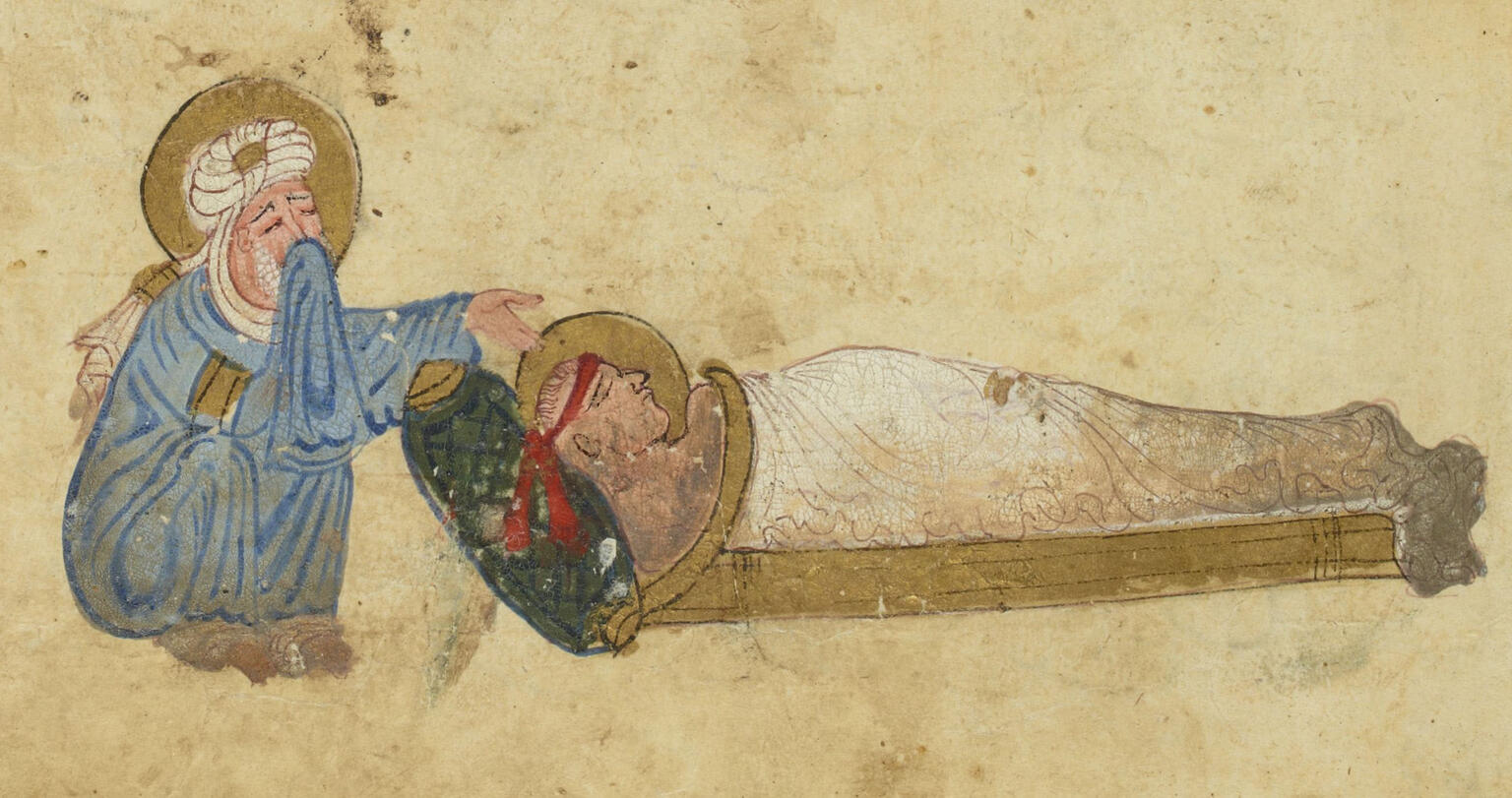 Illustration of a bearded, crying man in a robe and turban, his head surrounded by a gold halo, crouching beside a shrouded figure, also haloed, lying on a wooden bed.