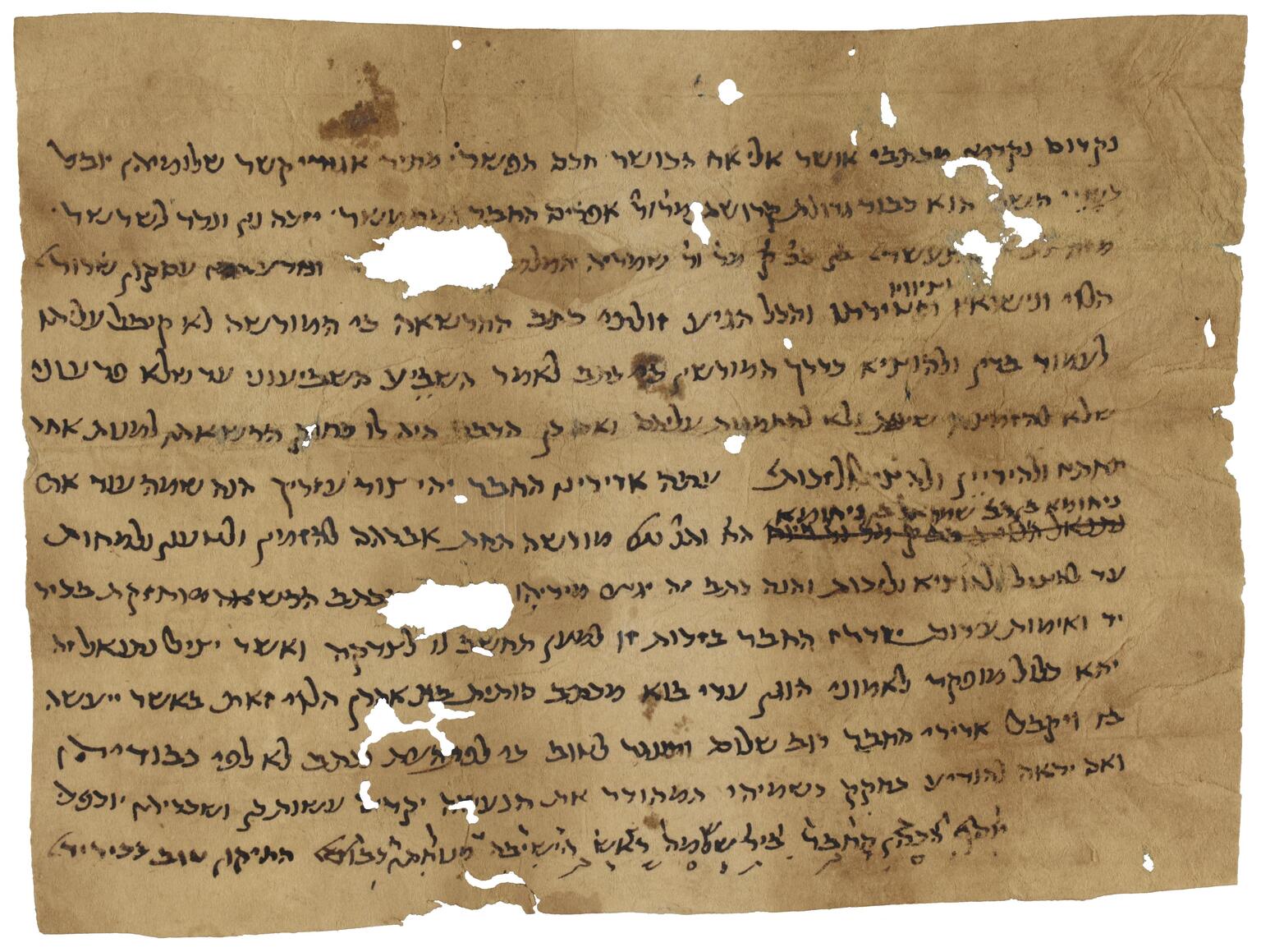 Damaged parchment with stains and holes, containing vowelless Hebrew script, one small fragment of which is crossed out and another annotated with letters.