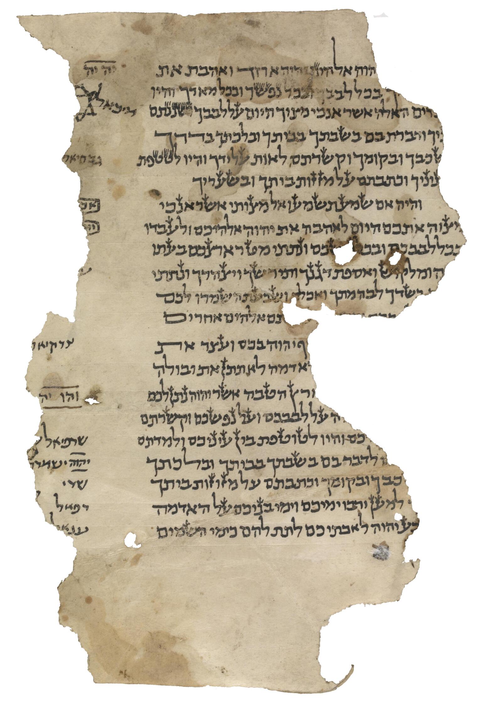 Damaged, irregular manuscript fragment with paragraphs of vowelless Hebrew script, obscured by a torn edge, and, at the other torn edge, a glimpse of a small six-pointed star and more script, some of which is underlined or boxed.