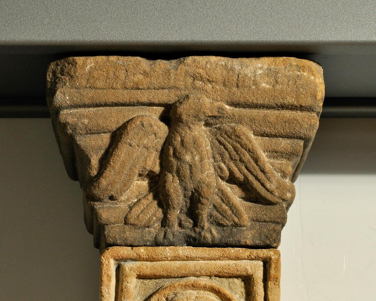 Photo of a stone capital featuring a relief of an eagle.