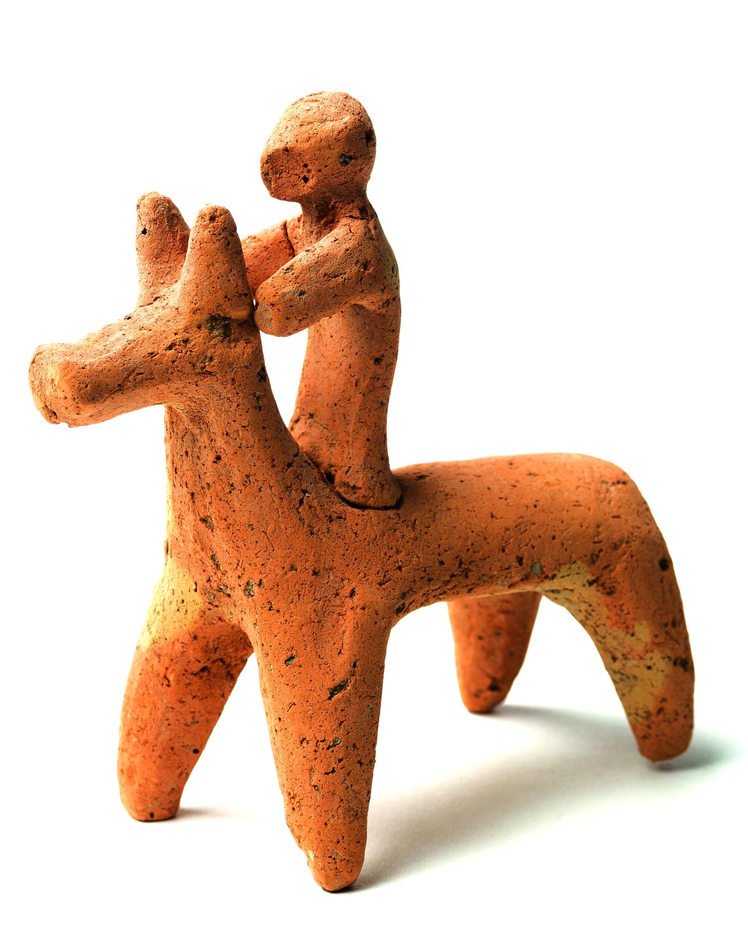 Terra-cotta figurine of horse and rider.