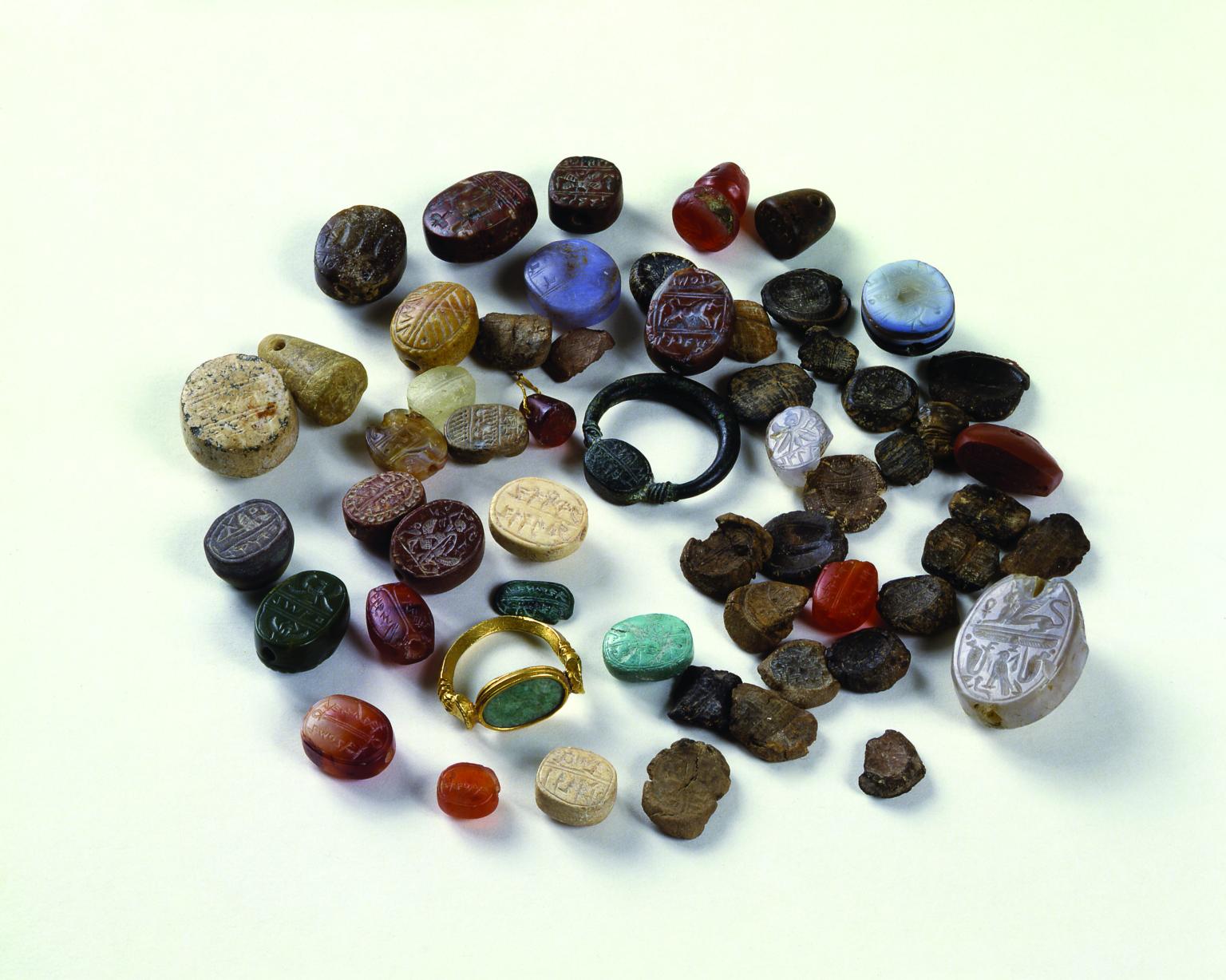 Inscribed seals of various sizes and shapes, mostly made of semi-precious stone, including two that are set in rings.