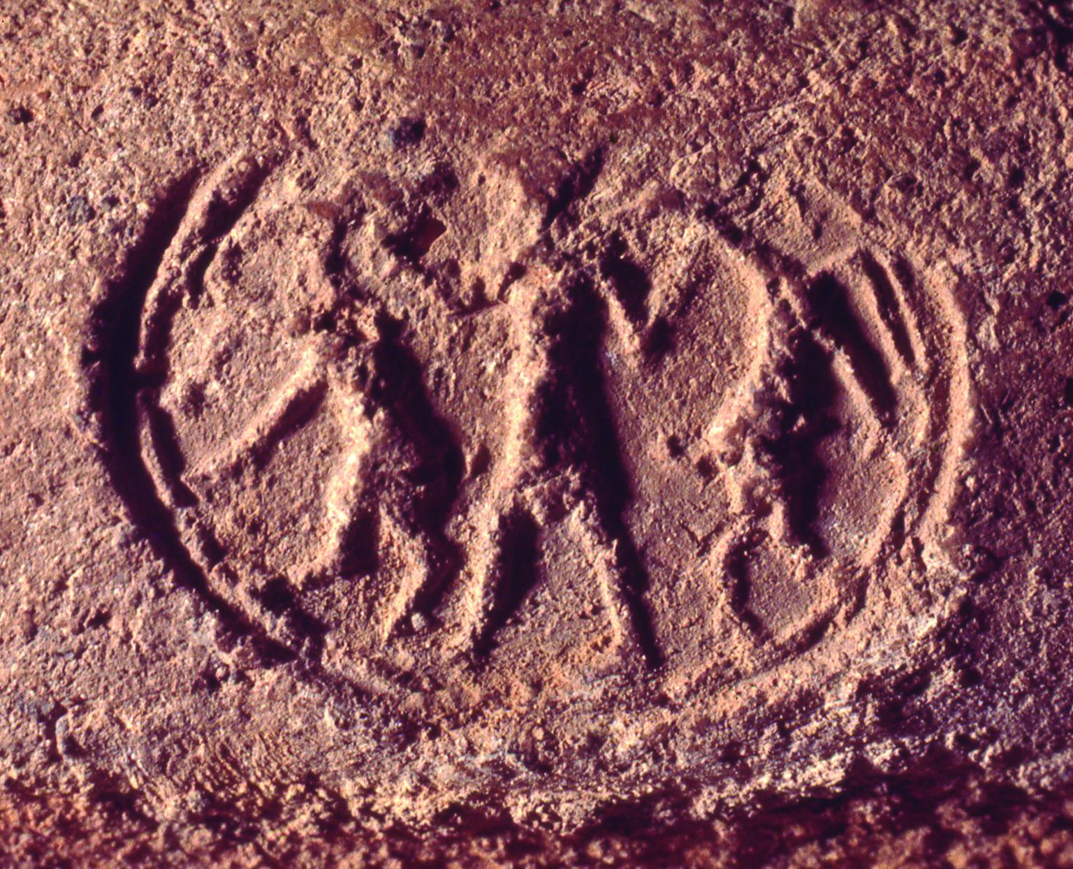 Seal impression with figure holding two ibex-like animals.