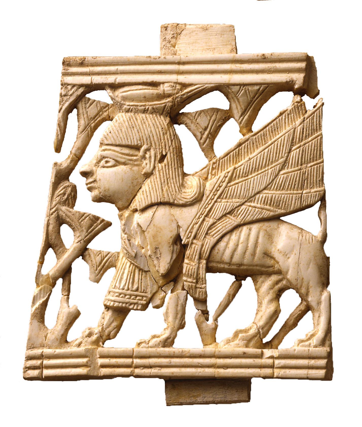 Ivory panel of lion with claws and teeth gripping bull in partial rectangular frame.