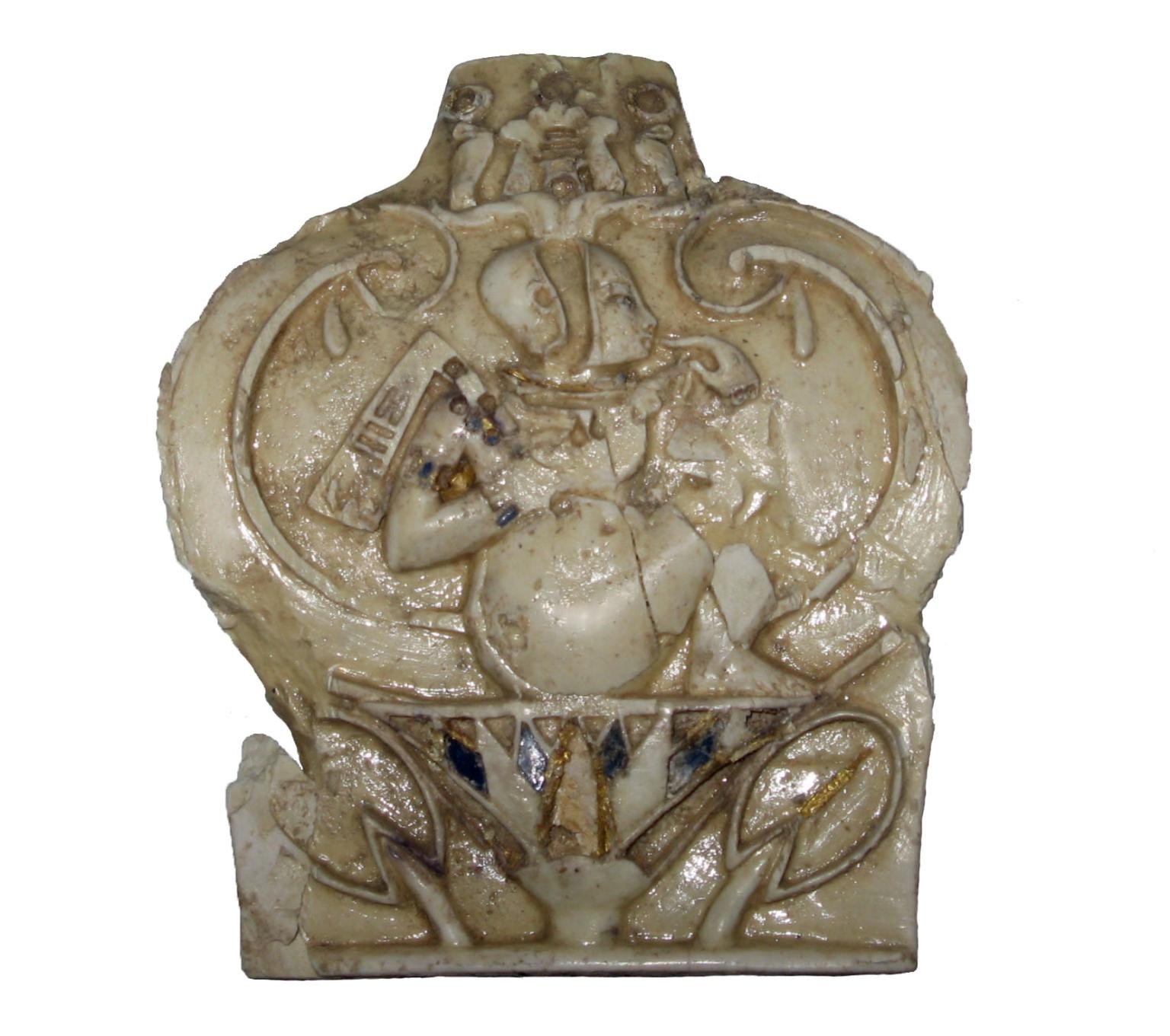Carved leaf-shaped ivory relief of child sitting on a lotus flower.