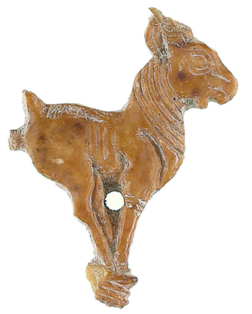 Ivory sculpture of goat with feet close together and hole in center.