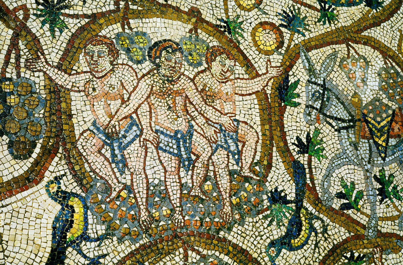 Ancient mosaic depicting three men in loincloths surrounded by grape clusters and leaves, with intricate patterns and vibrant colors.