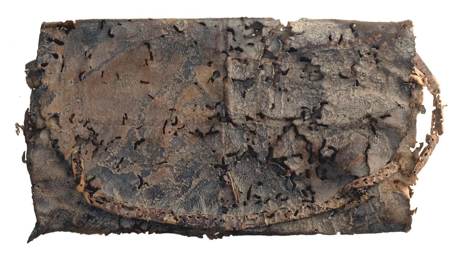 A folded rectangular piece of weathered, decayed leather with holes, dark stains, and a frayed strap or cord along one edge.