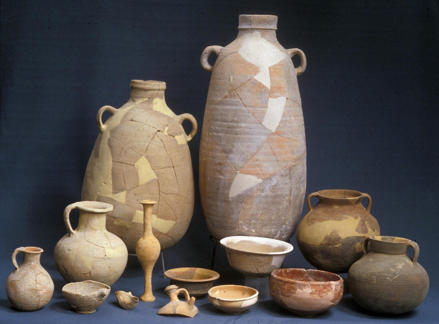 Collection of pottery jars, jugs, and containers, with some missing pieces.