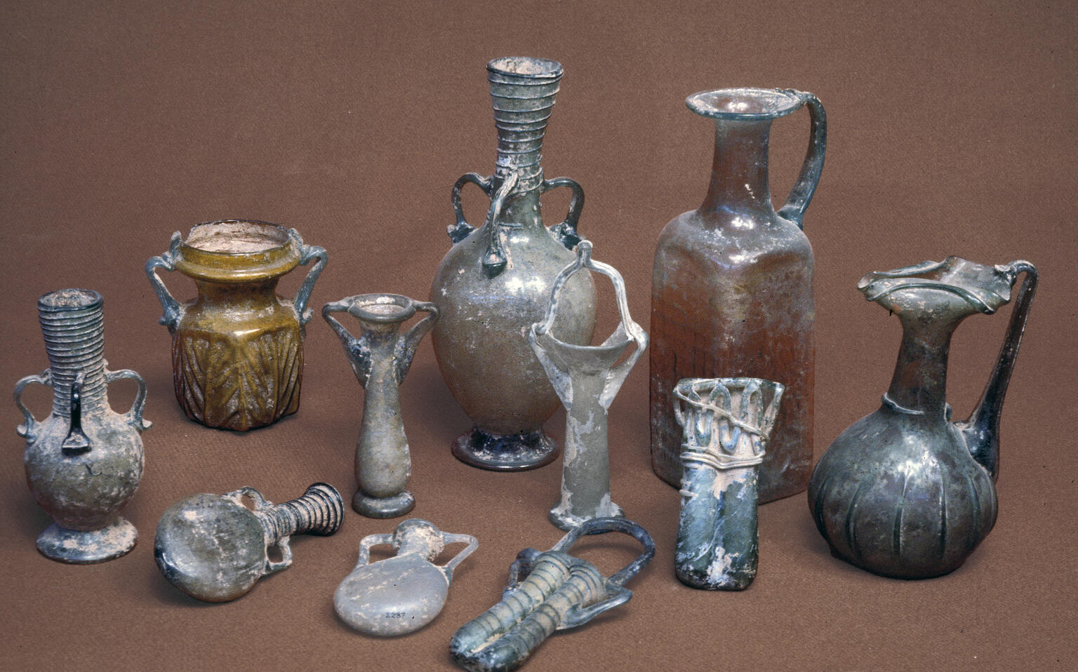 A collection of ancient glass vessels in various shapes and sizes.