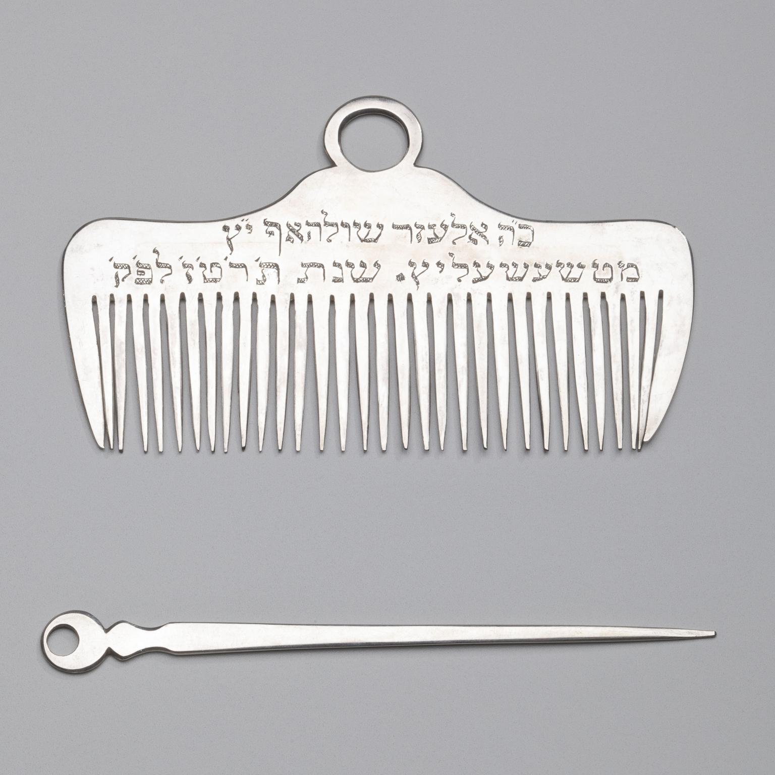 Silver comb and nail pick.