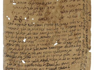 Worn manuscript page with handwritten Hebrew, including several lines running up the left margin, and a small curly drawing within the text.