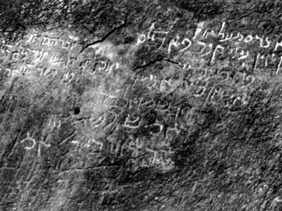 Photo of Judeo-Persian script carved into a rough stone surface.