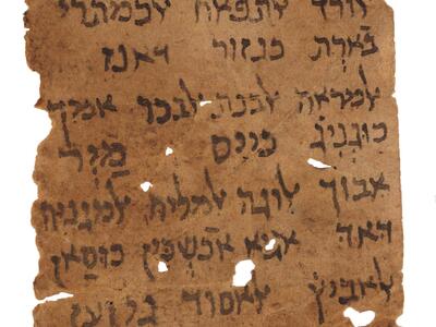 Damaged vertical parchment with fifteen lines of vowelless Hebrew script below two simple drawings, with several holes and tears.