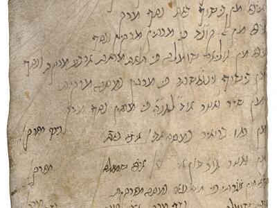 Worn manuscript page with handwritten vowelless Hebrew, with some lines spaced out across the page.
