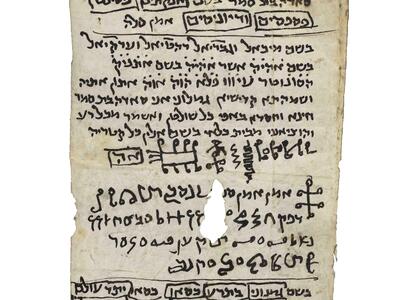 Irregular vertical manuscript with handwritten vowelless Hebrew, occasionally underlined or boxed, and a section of diagrams or symbols in which there is one large hole.