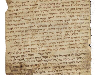 Long, stained parchment scroll with dense Hebrew script.