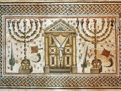 Ancient mosaic depicting two menorahs, an ornate central Torah ark, and various ritual objects, all bordered by an intricate geometric pattern.